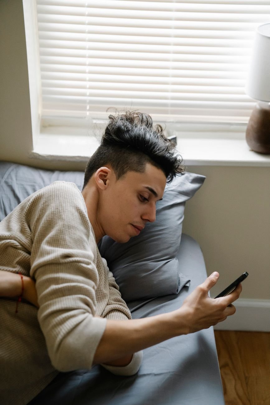 Young person looking at their phone, learning at home.